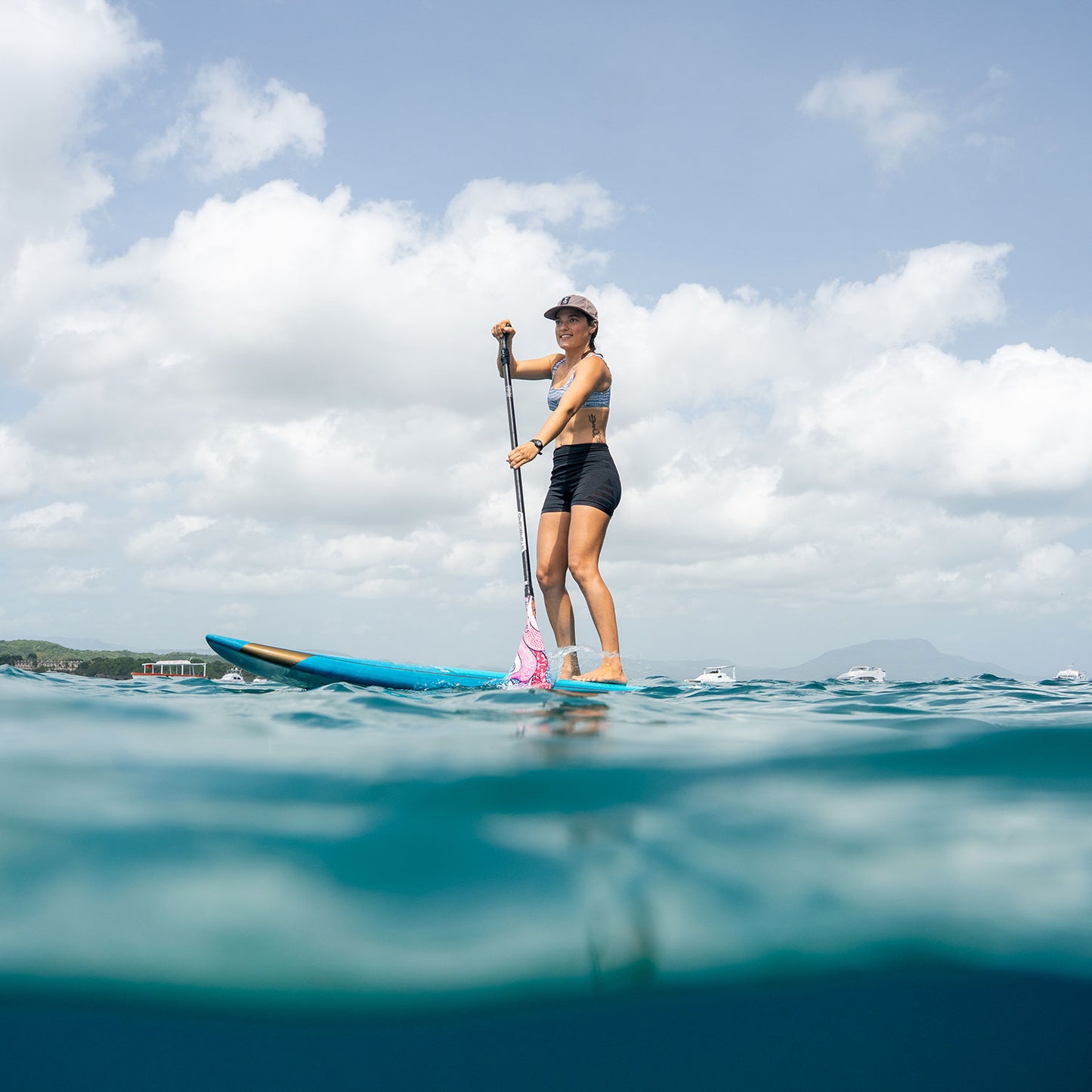 Stand-up paddleboard student paddling in calm Caribbean water