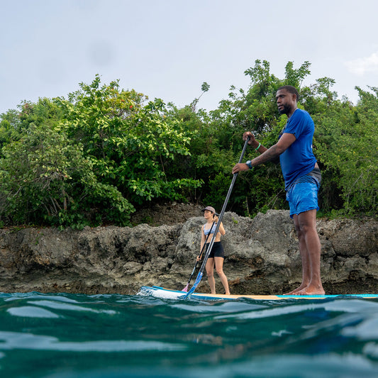 Beginner learning to paddle during SUP lesson at Kite Beach Cabarete